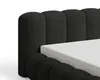 Close-up of a black upholstered bed frame with a white mattress. Voir les images du produit
