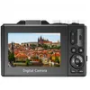 The back of a black digital camera displaying a cityscape on its screen. Produktbild-Vorschau