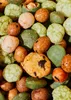 A close-up, overhead view of a pile of mixed rice crackers and peanuts. Produktbild-Vorschau