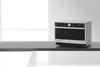 A Whirlpool microwave oven is displayed on a dark countertop against a white background. Produktbild-Vorschau
