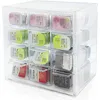 A clear plastic storage box with multiple drawers, filled with small packages of contact lenses. Produktbild-Vorschau