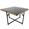 A square outdoor dining table with a black glass top and a woven tan rope trim around the edges, supported by black metal legs forming an X shape. Produktbild-Vorschau
