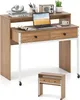 A desk with a laptop, headphones, and office supplies on a white background. A smaller, matching desk is shown in the foreground. Produktbild-Vorschau