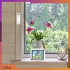 A weather station is displayed on a windowsill next to a vase of flowers and a lantern, with a view of greenery outside the window. Anteprima dell’immagine prodotto