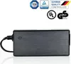 A black power adapter with a cable attached, shown from the side against a white background. Several certification logos are visible in the upper right corner. Produktbild-Vorschau