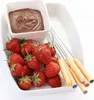 Strawberries and chocolate fondue on a white platter. Produktbild-Vorschau