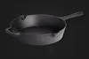 A cast iron frying pan is shown against a black background. Produktbild-Vorschau