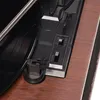 A close-up view of a record player's controls and part of the turntable. Produktbild-Vorschau