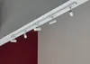 A white track lighting system with multiple adjustable LED spotlights mounted on a ceiling. Náhľad obrázku produktu