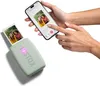 A person is using a smartphone to print a photo using a portable photo printer. Náhľad obrázku produktu