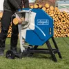 A person is using a log saw in a grassy outdoor area with a large pile of cut logs in the background. Produktbild-Vorschau