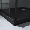 Close-up view of the base of a modern black shower cabin with a glass door and a drain. Produktbild-Vorschau