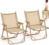 Two camping chairs are shown, with a woman demonstrating how to fold one in the background. Produktbild-Vorschau