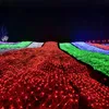 A field of lights at night, with different colored sections. Voir les images du produit