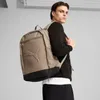 A man wearing a black sweater and black pants is modeling a brown Puma backpack. Anteprima dell’immagine prodotto