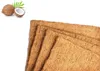 A stack of coconut fiber mats with two coconuts and a leaf in the upper left corner. Produktbild-Vorschau