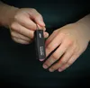 Hands holding a black external SSD. Anteprima dell’immagine prodotto