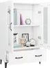 An open white cabinet with shelves and drawers, displaying various decorative items and books. Náhled obrázku produktu