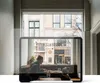 A person sits at a table in a cafe, with a tablet screen reflecting the cafe scene and the street outside. Anteprima dell’immagine prodotto