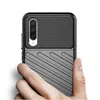 A hand holding a black smartphone case with a textured design. Produktbild-Vorschau