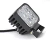 A close-up studio shot of a black LED work light with a metal bracket and a black cable, set against a white background. Produktbild-Vorschau