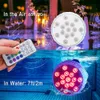 A composite image showing an LED submersible light, with one part above water displaying the remote control and the other part underwater showing the illuminated light. Produktbild-Vorschau