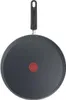 A top-down view of a black frying pan with a red logo in the center and a black handle. Voir les images du produit