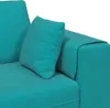 A close-up view of a turquoise sofa with a pillow. Produktbild-Vorschau