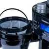 A close-up view of a black coffee maker, focusing on the filter basket and the control panel. Anteprima dell’immagine prodotto