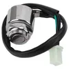 A close-up studio shot of a motorcycle ignition switch with wires and a connector. Produktbild-Vorschau