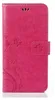 A pink flip phone case with a floral and butterfly embossed design. Produktbild-Vorschau