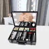 A makeup case with a mirror and lights, reflecting a person's shoulder and arm. Produktbild-Vorschau