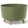 A green planter with wooden legs on a white background. Anteprima dell’immagine prodotto