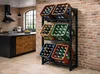 A kitchen with a brick wall and a metal rack holding crates of bottles. Produktbild-Vorschau