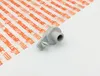 A gray plastic part is placed on a white surface next to a sheet of paper with orange stripes and the STIHL logo repeated. Produktbild-Vorschau