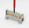 A close-up shot of a terminal block with multiple screws being tightened by a screwdriver. Produktbild-Vorschau