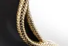 A close-up of a gold-colored snake sculpture, likely a mirror frame, against a black and white background. Produktbild-Vorschau