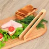 A wooden cutting board with a sandwich, toast, and dill. Náhled obrázku produktu