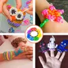 A collage of four images showing various crafts made from colorful rubber bands, including an owl, a flower bracelet, bracelets and a ring, and finger puppets. Podgląd zdjęcia produktu