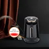 A black Turkish coffee maker with gold accents is displayed on a dark surface, with a brown curtain and a decorative plant in the background. A circular overlay highlights the product's power. Produktbild-Vorschau