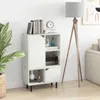 A white bookshelf with books and decorative items on top, next to a floor lamp. Produktbild-Vorschau