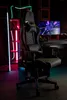 A gaming chair is set up in a room with neon lighting and a computer monitor. Produktbild-Vorschau