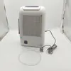 A white dehumidifier with a power cord and a clear plastic tube sits on a white surface. Voir les images du produit