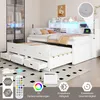 A white storage bed with drawers and a pull-out guest bed, featuring LED lighting and a headboard with shelves. Anteprima dell’immagine prodotto