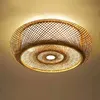 A close-up, low-angle shot of a woven bamboo ceiling light fixture. Náhled obrázku produktu