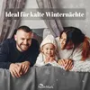 A family (father, mother, and young child) lying on a bed, smiling and looking at the camera. The background has a winter theme with snowflakes. The text "Ideal für kalte Winternächte" is overlaid on the image. Produktbild-Vorschau