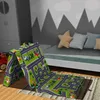 A children's play mat with a road pattern is folded and placed on a rug in a bedroom setting. Náhľad obrázku produktu