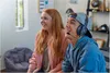 Two young people, a girl and a boy, are sitting and looking to the side with smiles on their faces, seemingly engaged in a video game. The boy is wearing a headset. Anteprima dell’immagine prodotto