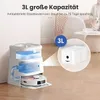 A robot vacuum cleaner docking station with water tanks and a dust bag compartment, shown in a home setting with a dog and person in the background. Produktbild-Vorschau