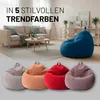 A living room scene with a sofa and a beanbag chair, and a separate row of beanbag chairs in different colors. Voir les images du produit
